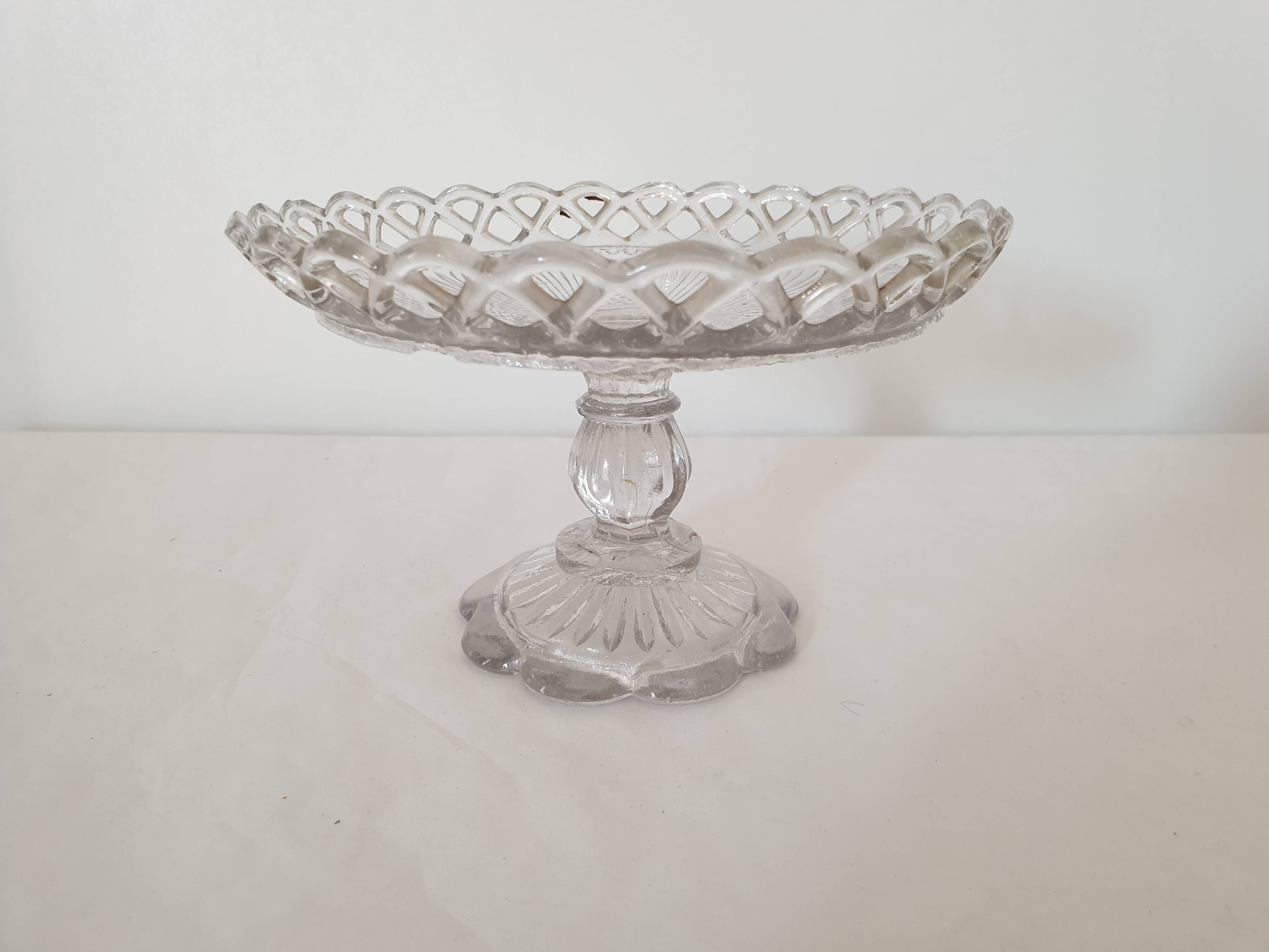Old cup in molded glass colorless decorative table mignardises