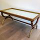 Coffee table in patinated and gilded carved wood with mirror top