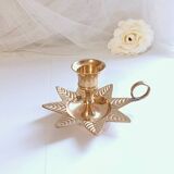 Golden brass hand candle holder decorated with leaves