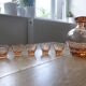 Carafe and 5 pink glass liqueur glasses with a gold rim 2008123
