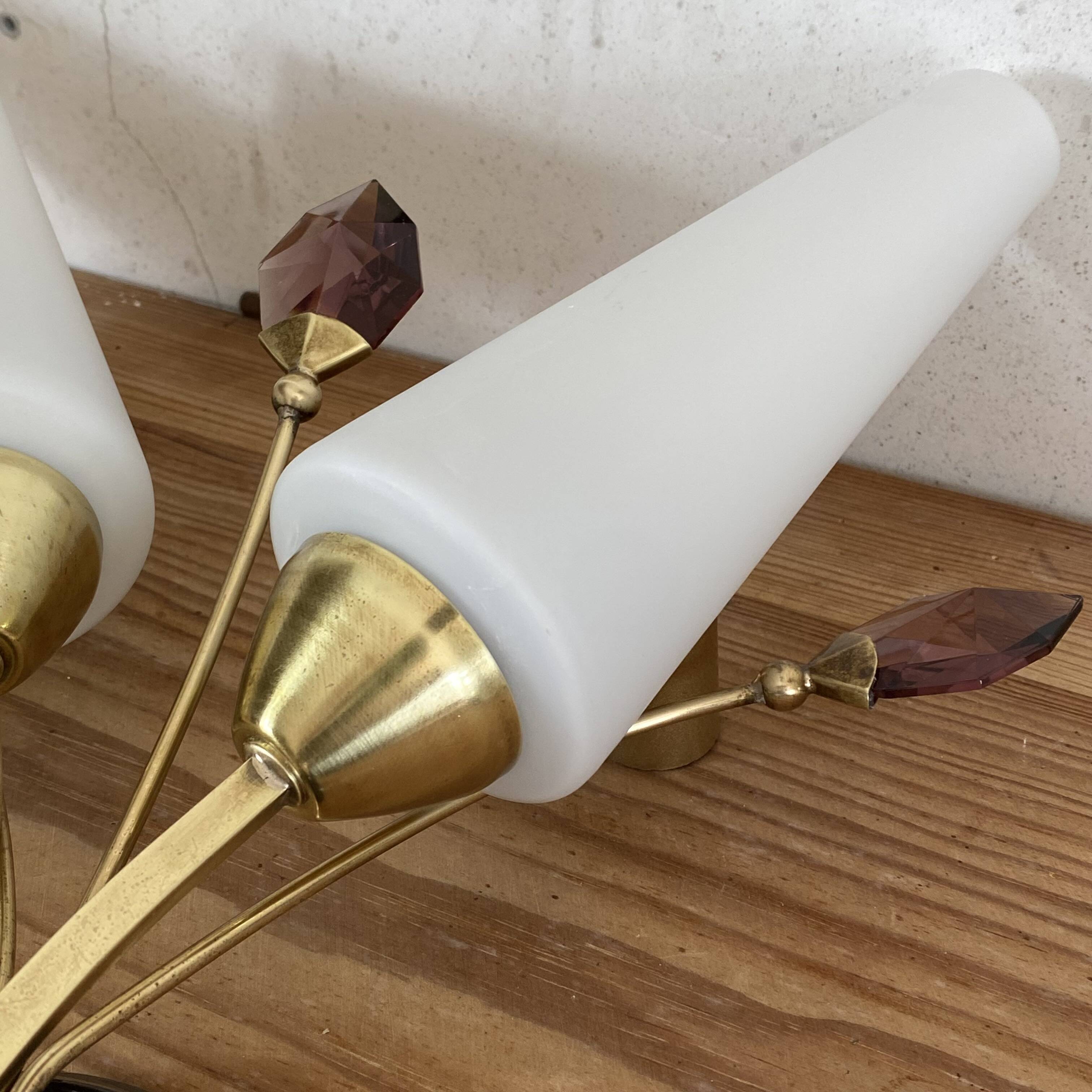 Pair of wall sconces in brass with white glass tulips.