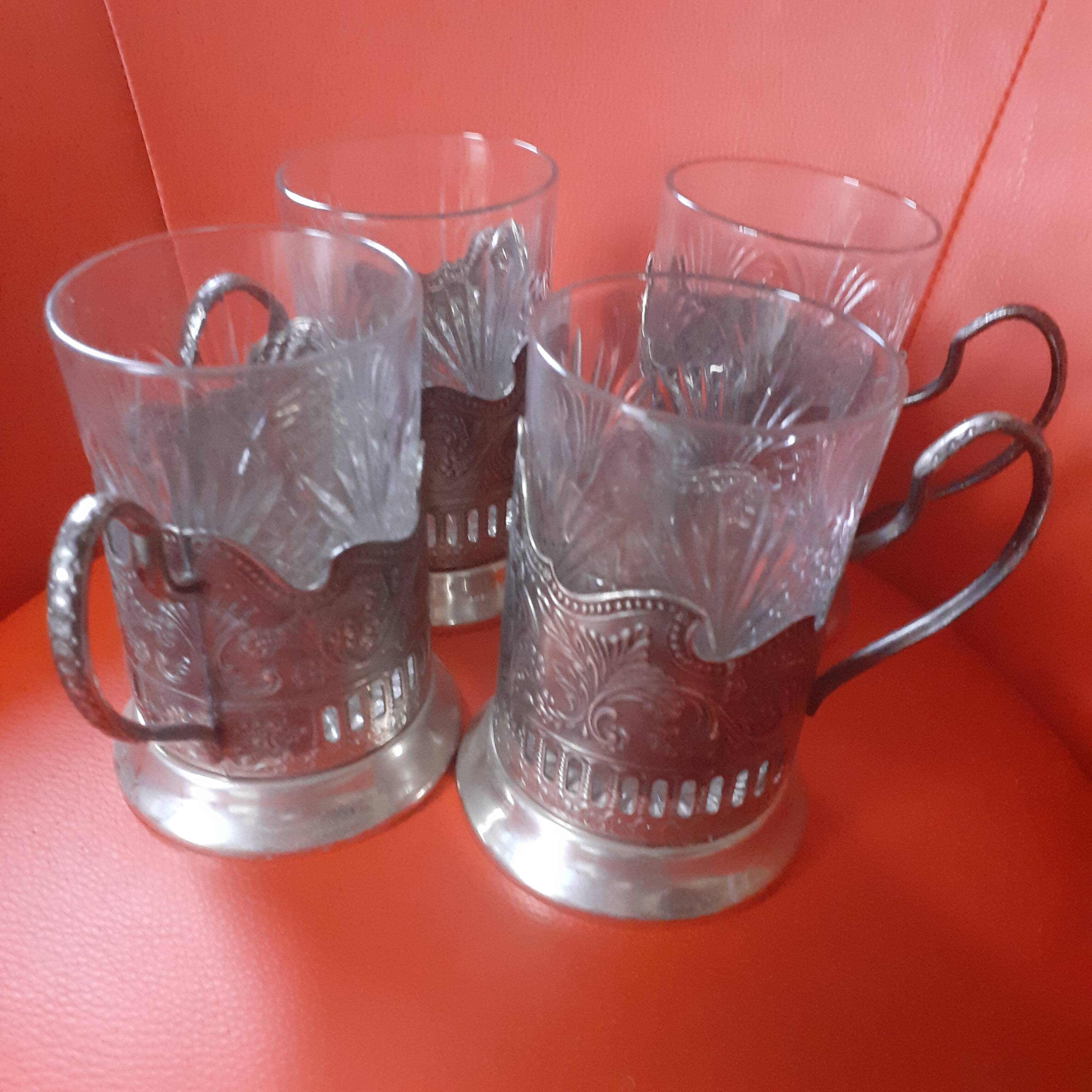 4 glasses engraved on their silver metal support;
