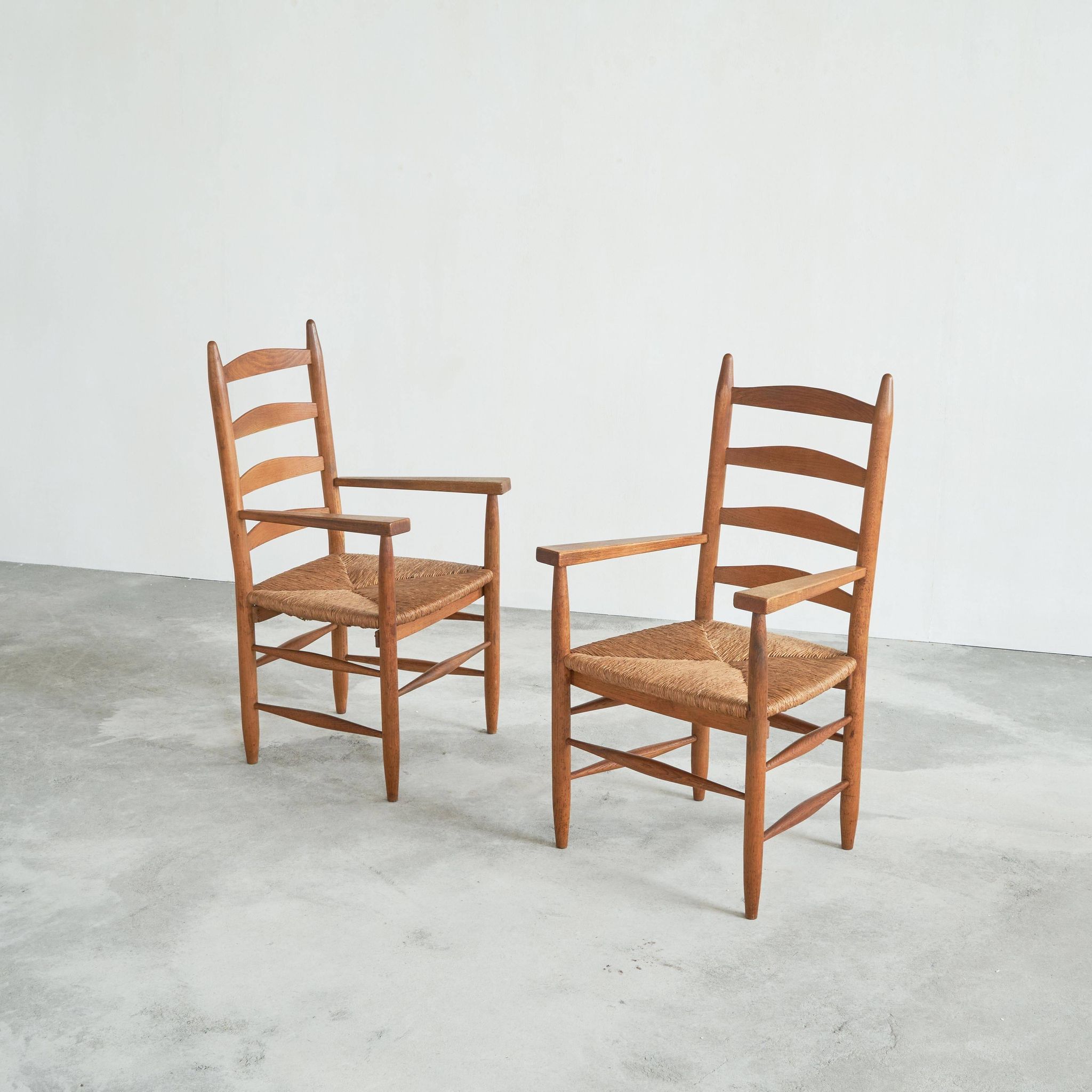 Set of 2 oak and wicker armchairs, mid-20th century.