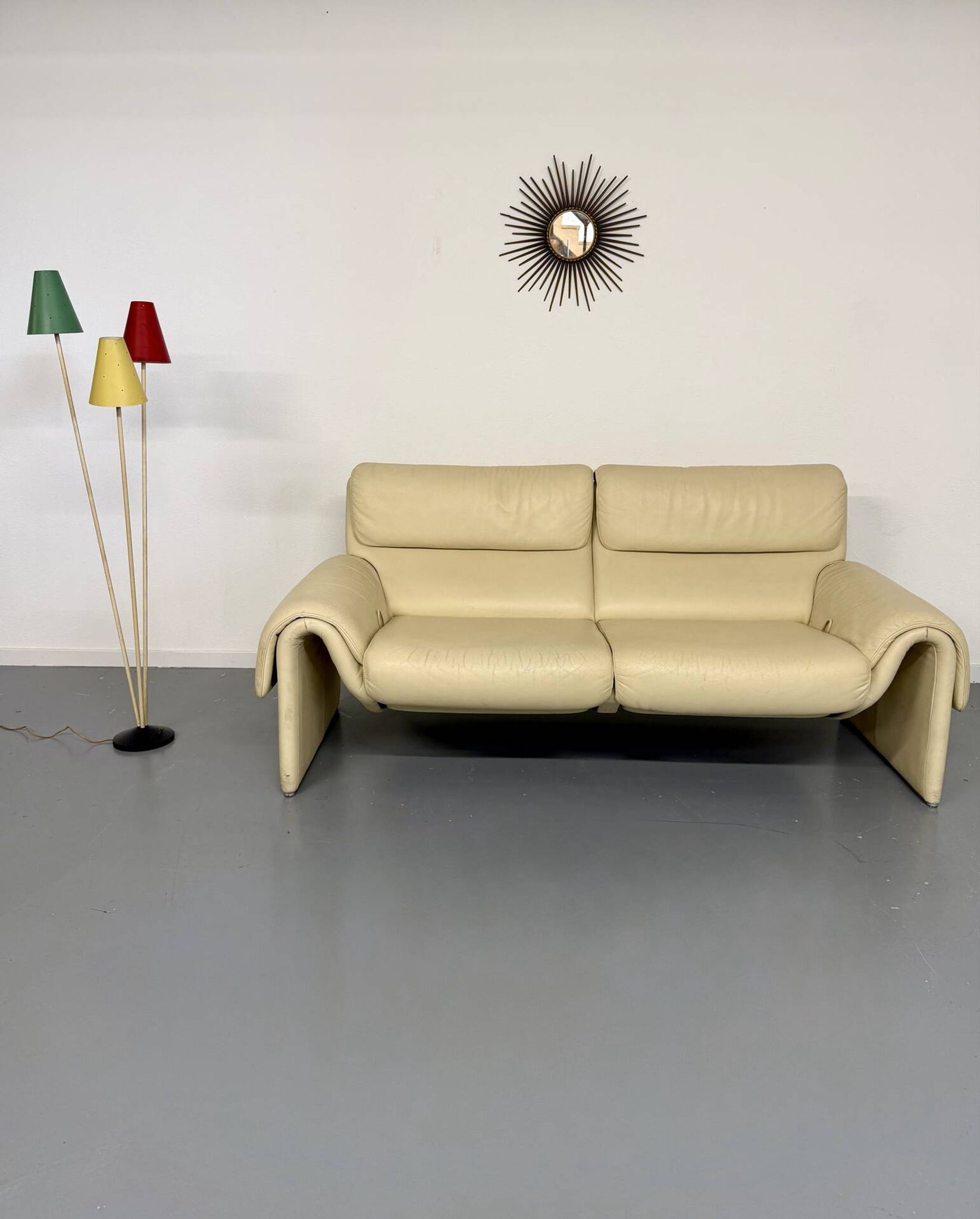 Two-seater designer sofa De Sede DS-2011 in cream leather with adjustable backrest.