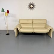 Two-seater designer sofa De Sede DS-2011 in cream leather with adjustable backrest.