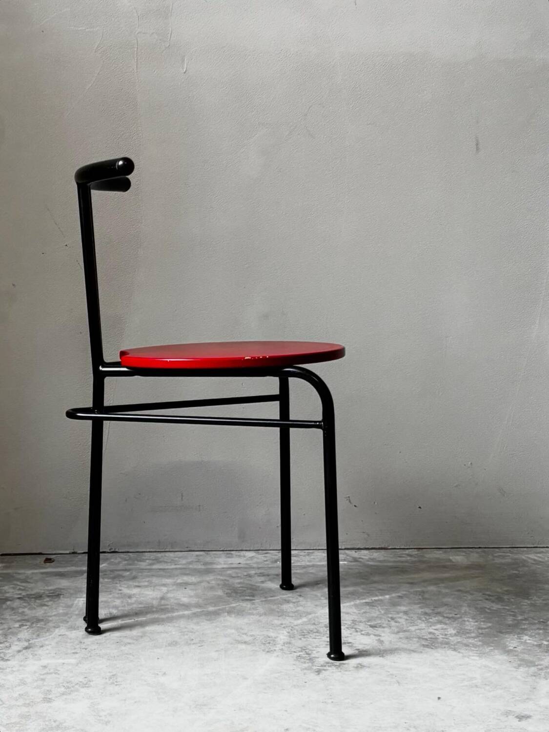 Set of 4 vintage black metal chairs with red lacquered seats.