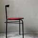 Set of 4 vintage black metal chairs with red lacquered seats.