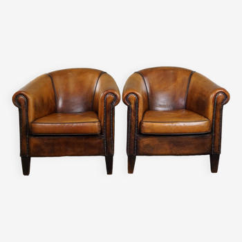Set of two vintage sheep leather club armchairs