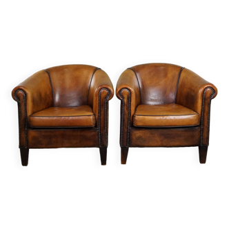 Set of two vintage sheep leather club armchairs