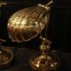 Pair of articulated brass lamps in the shape of a shell.