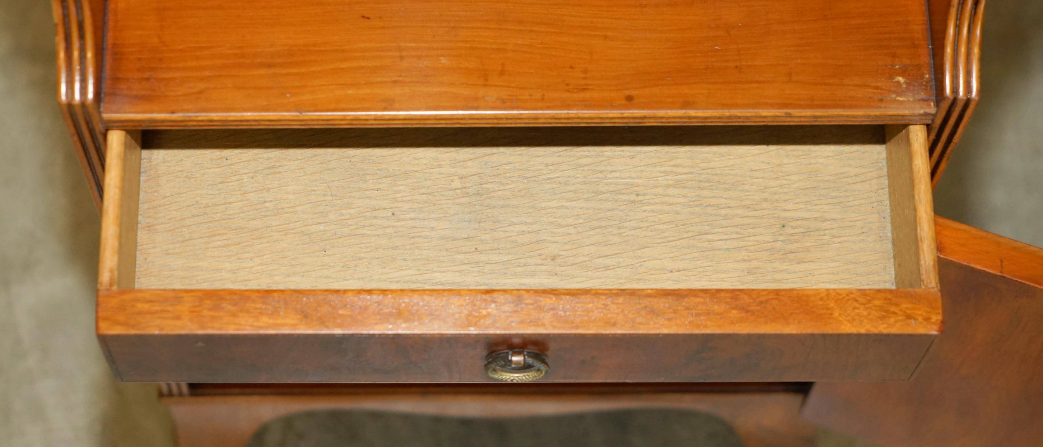 Pair of vintage English hardwood bookcases in a cascade style with cupboards.