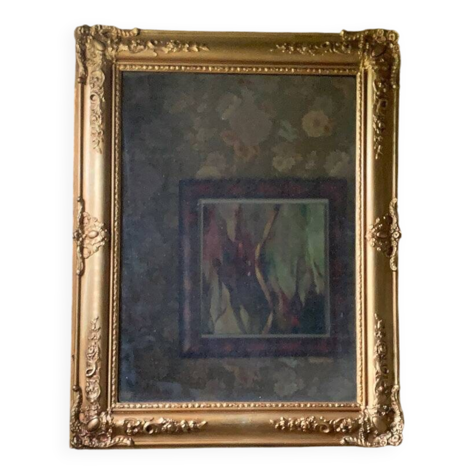 Miroir ancien en bois sculpté doré à décor de fleurs