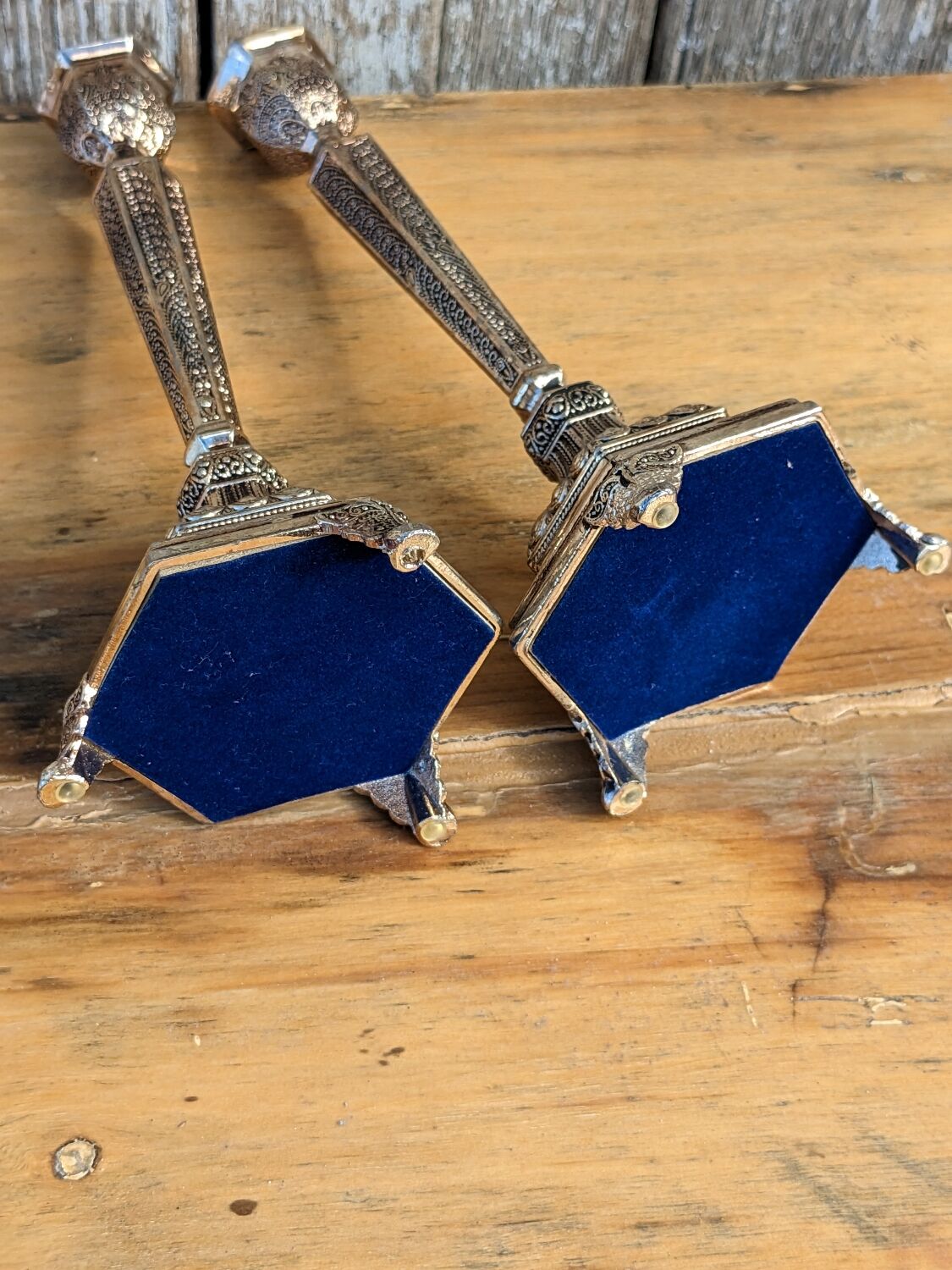 Pair of chiseled metal candle holders