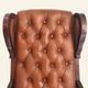 Rocking chair with footrest, wood and tufted leather