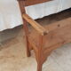 Church bench in fir tree with armrests