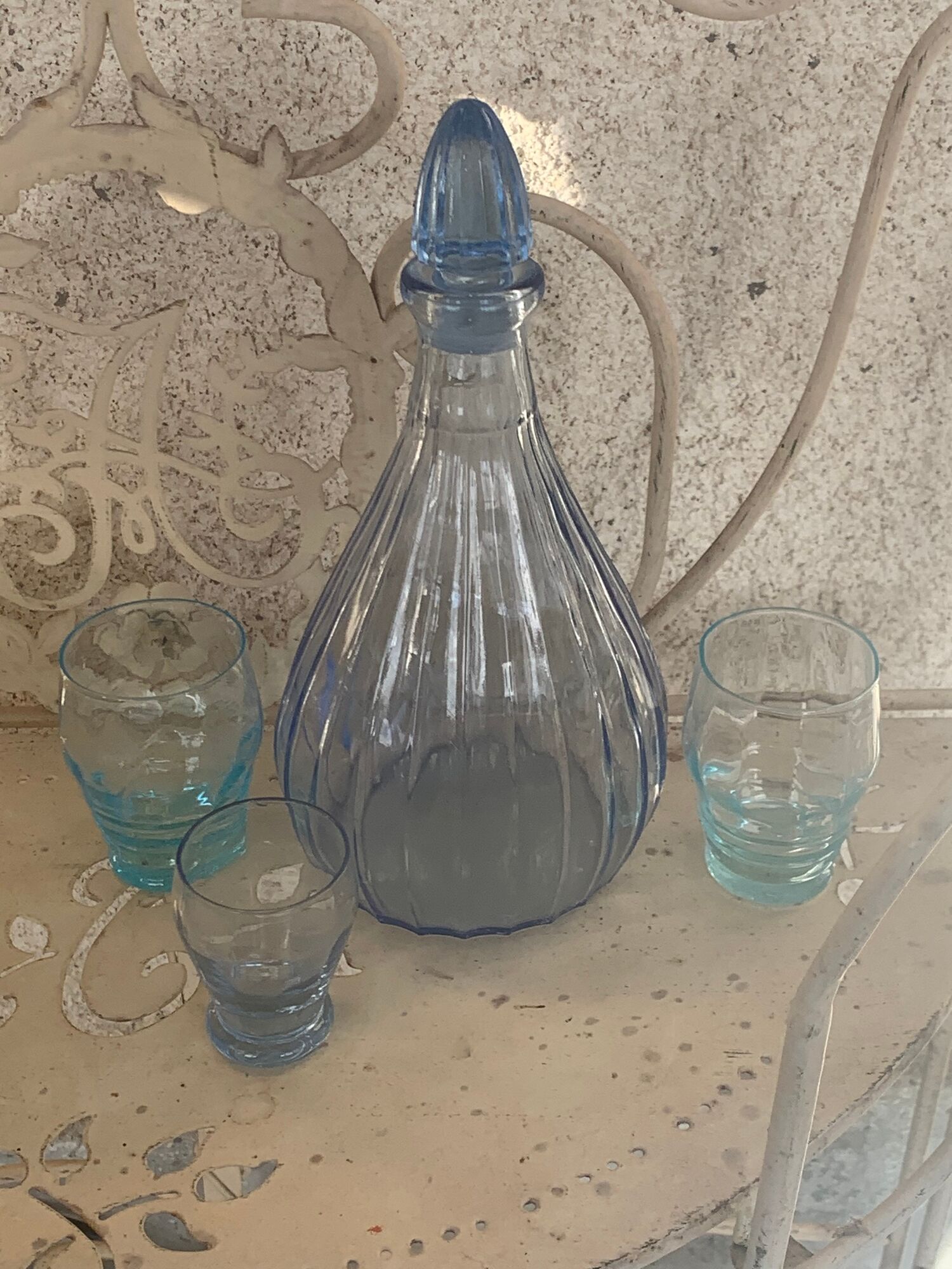 Liquor service consisting of a blue glass decanter and. 3 small antique glasses