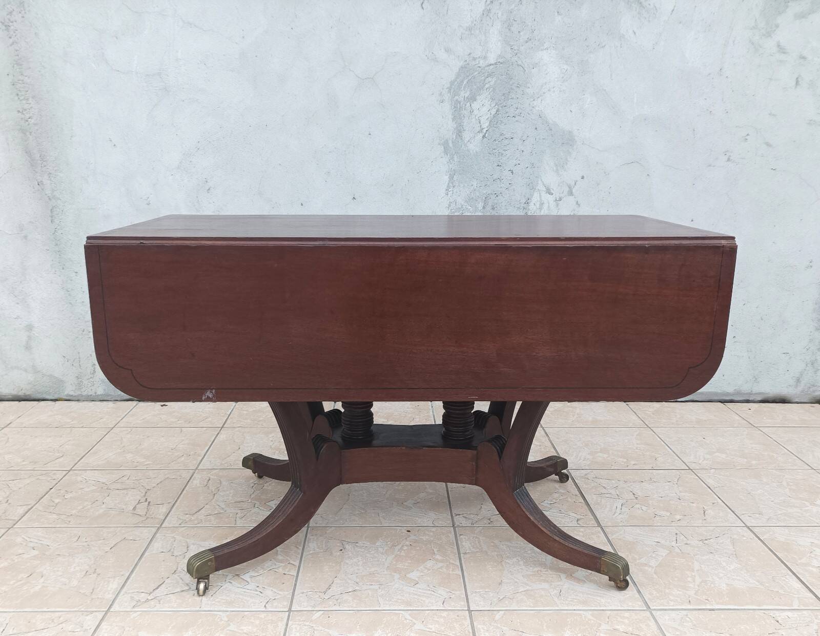 19th-century English style mahogany drop-leaf table.