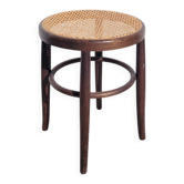 Vintage low stool with caning and bent wood.