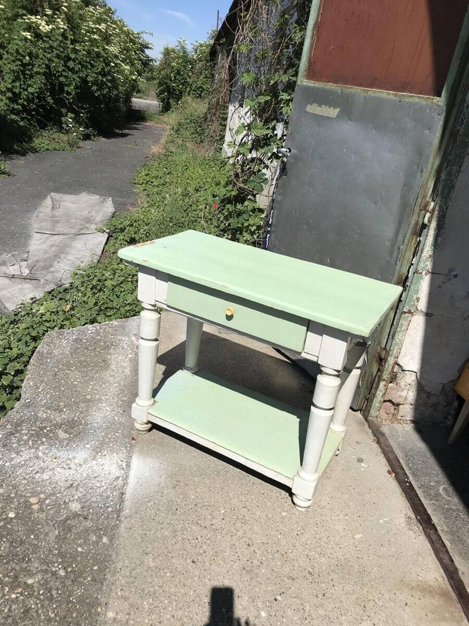 Rustic wooden dining table painted white and pale green, with a central drawer, 1950s.