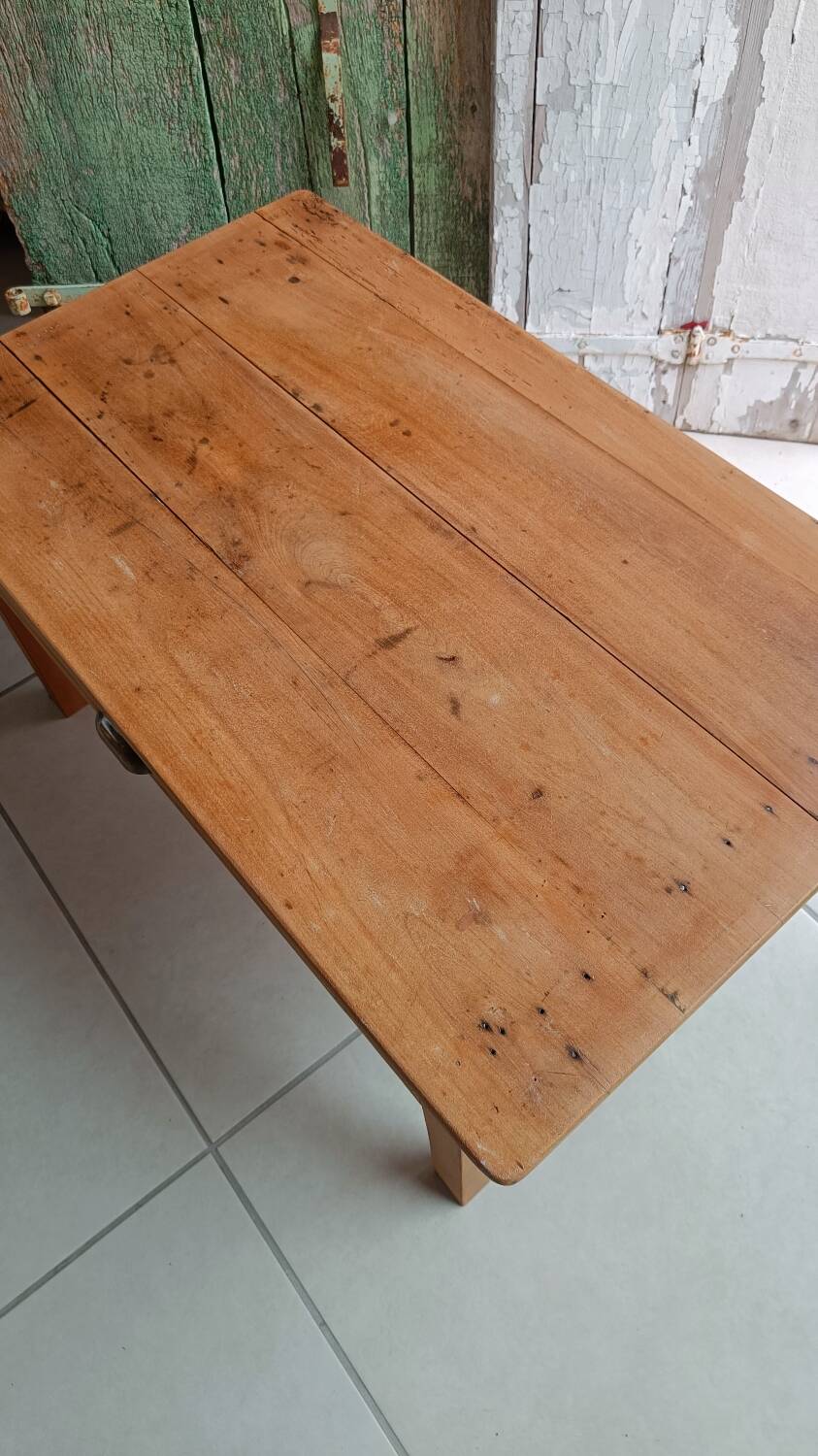 Coffee table with raw wood and a large drawer.
