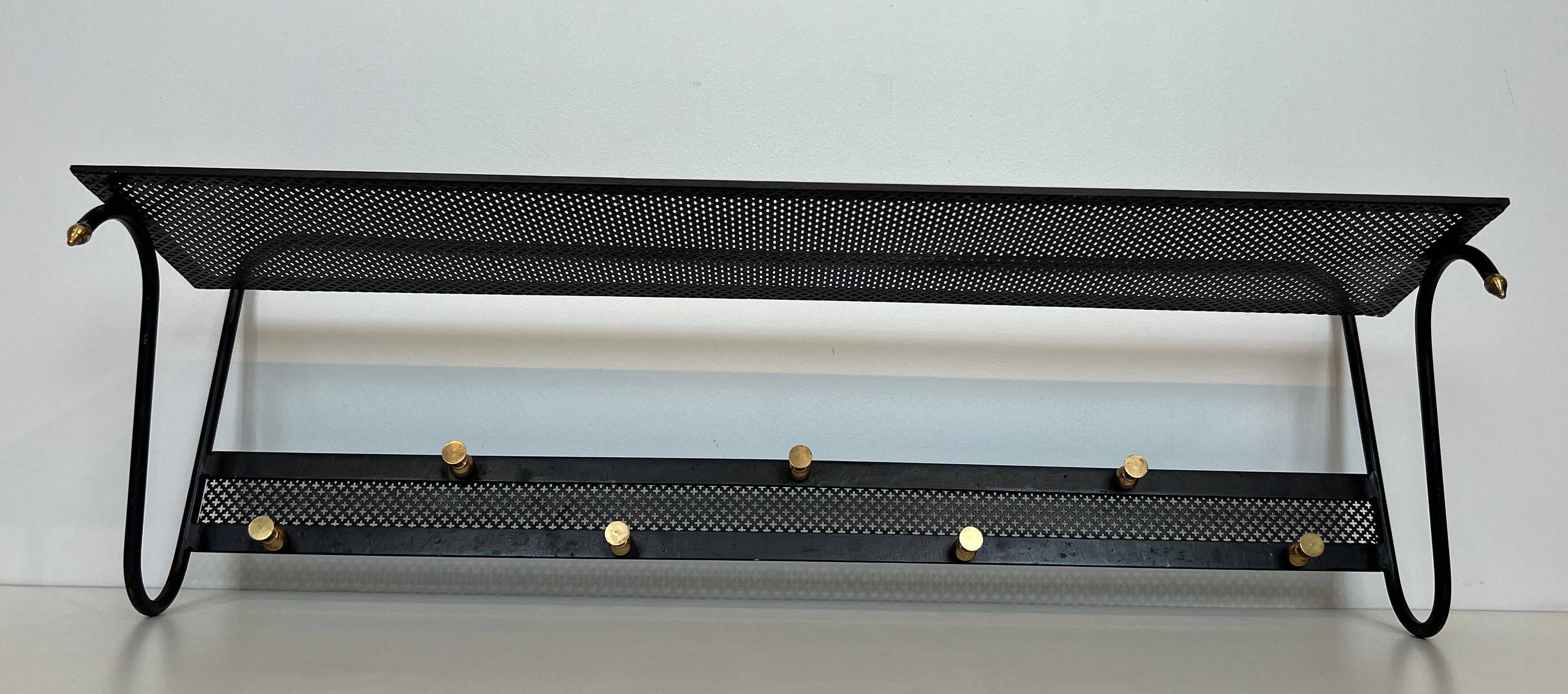 Coat rack in black lacquered metal, perforated sheet metal and brass in the style of Mathieu Matégot