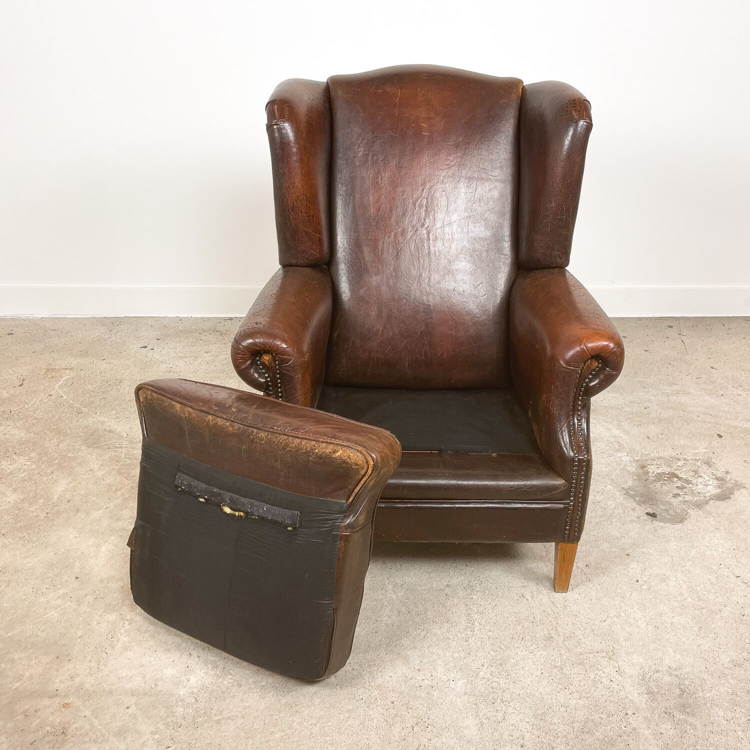 Dark brown vintage sheep leather wingback armchair