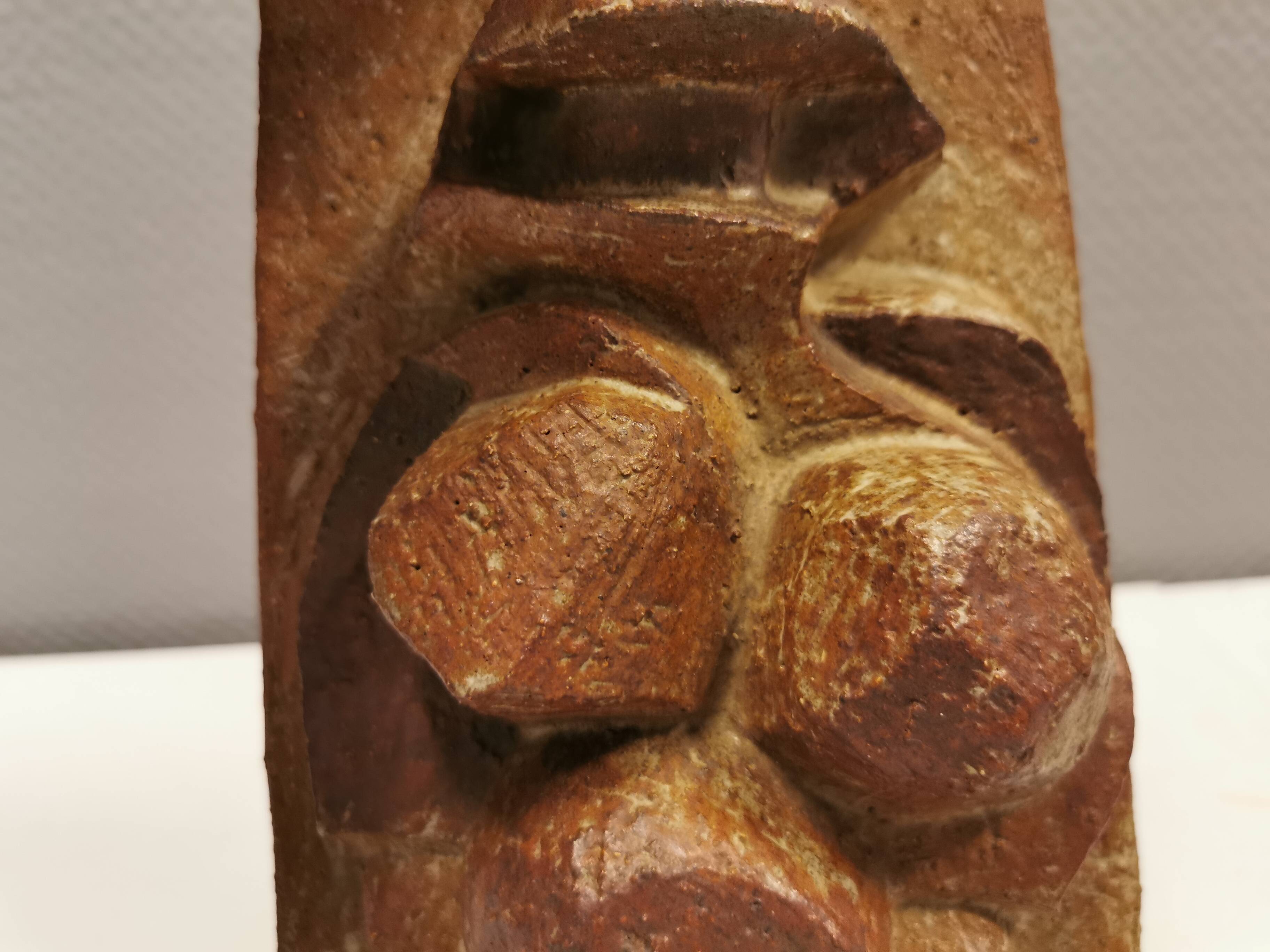 Ceramic relief portraying a lady. Emerging out of the background.