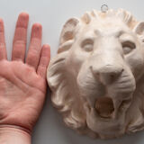 Lion's head in painted plaster