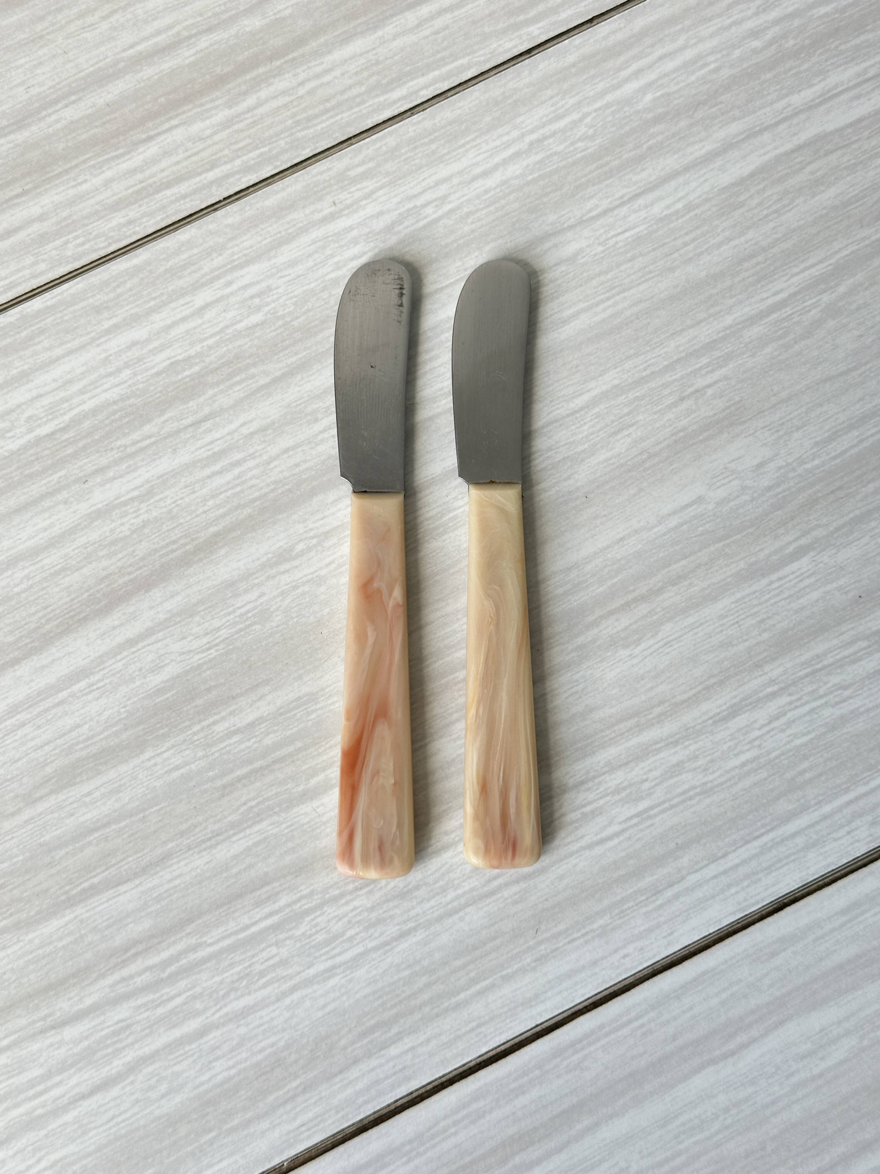 Pink bakelite butter knives.
