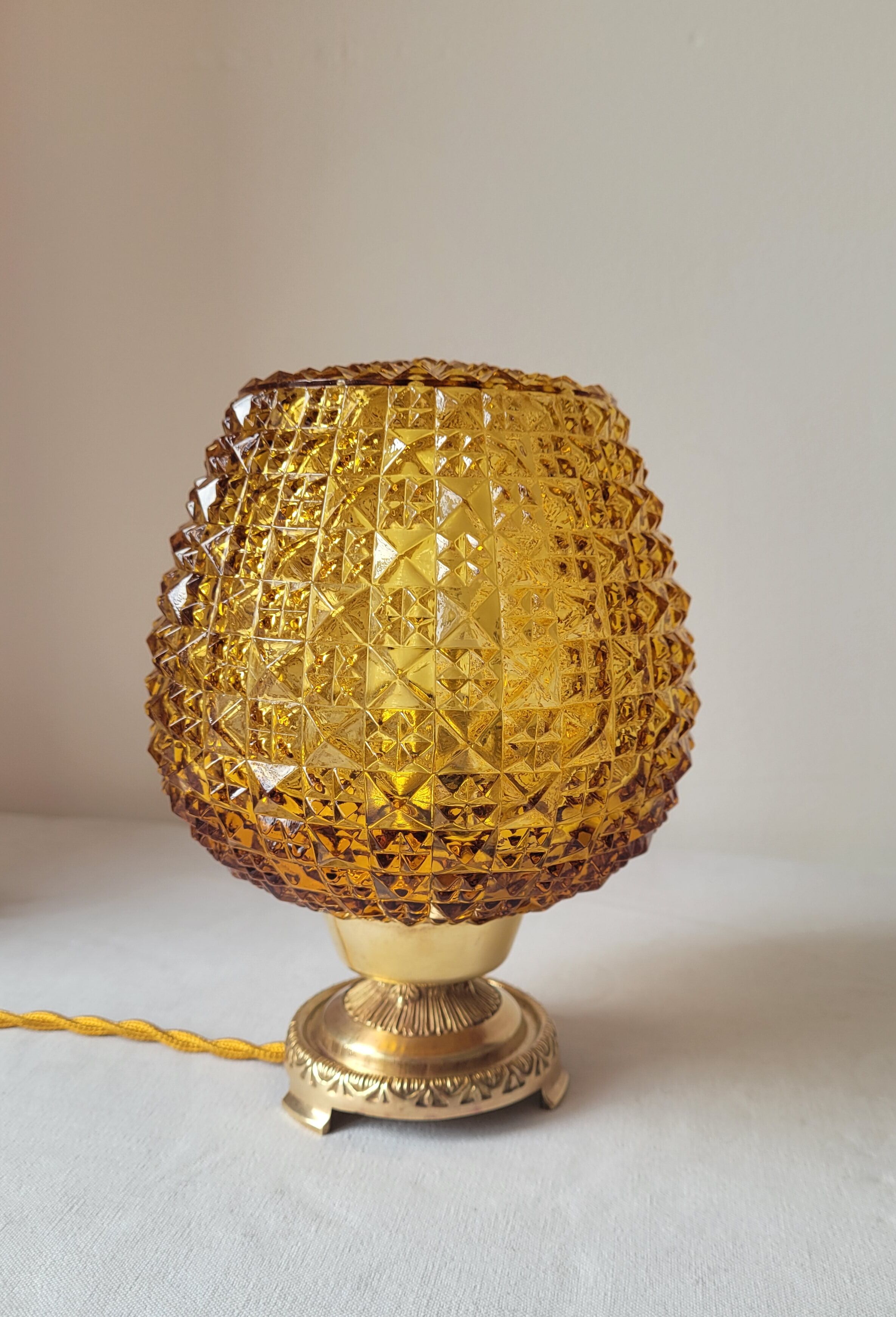 Bedside lamp in amber glass and brass