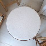 Rattan and boucle fabric pouf