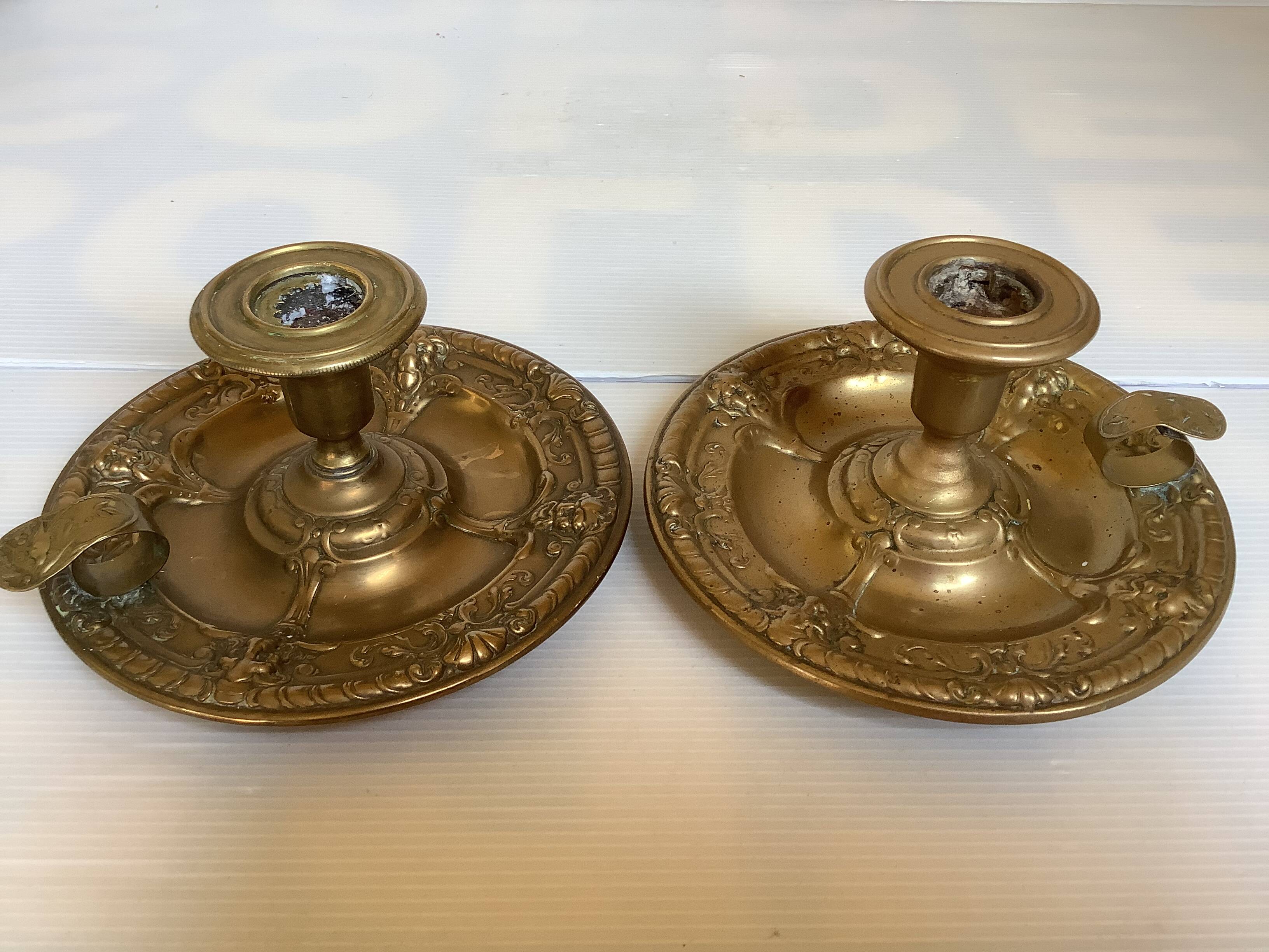 Pair of brass cellar rat candlesticks mascarons