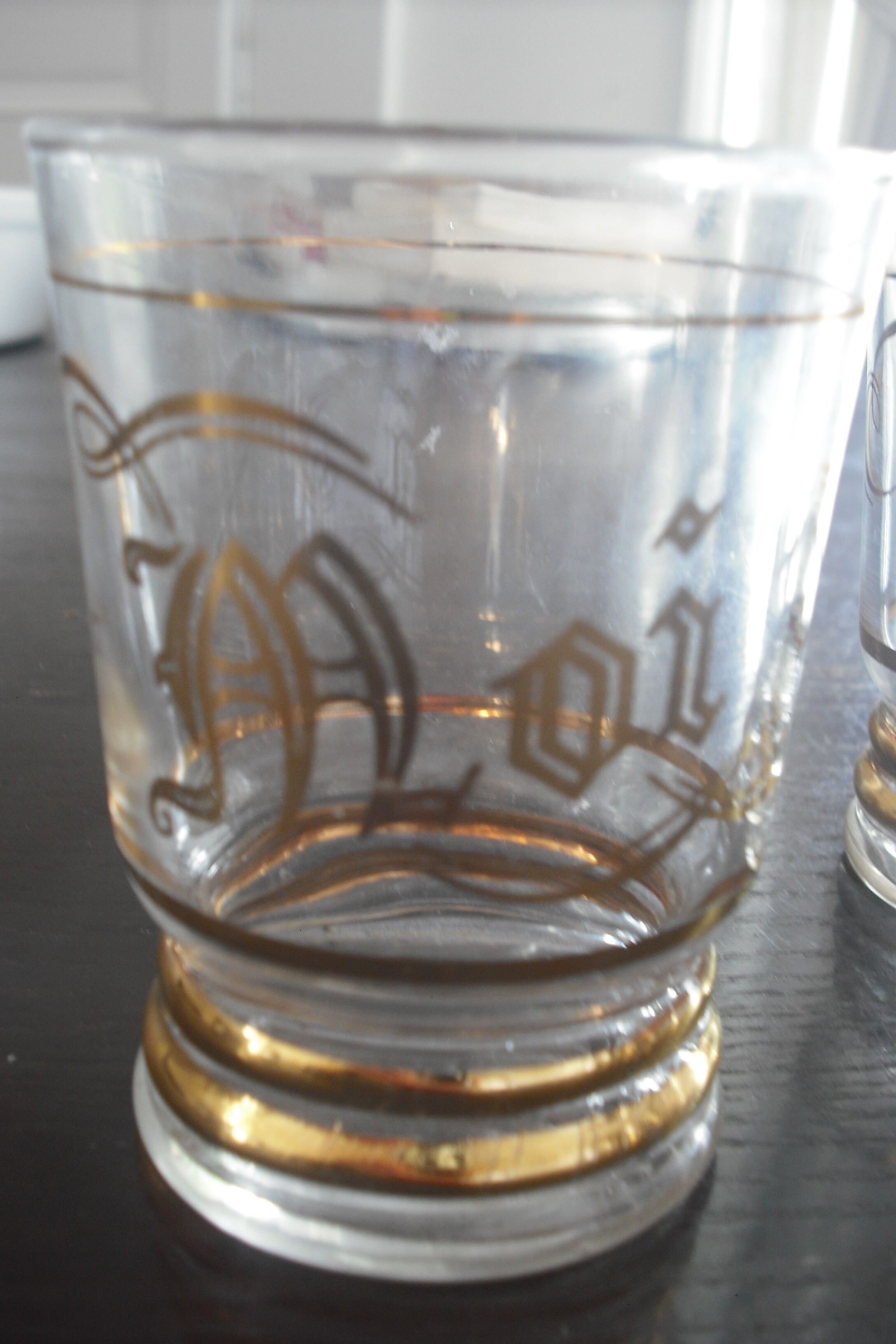 4 glasses engraved gold, one bottle