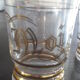 4 glasses engraved gold, one bottle
