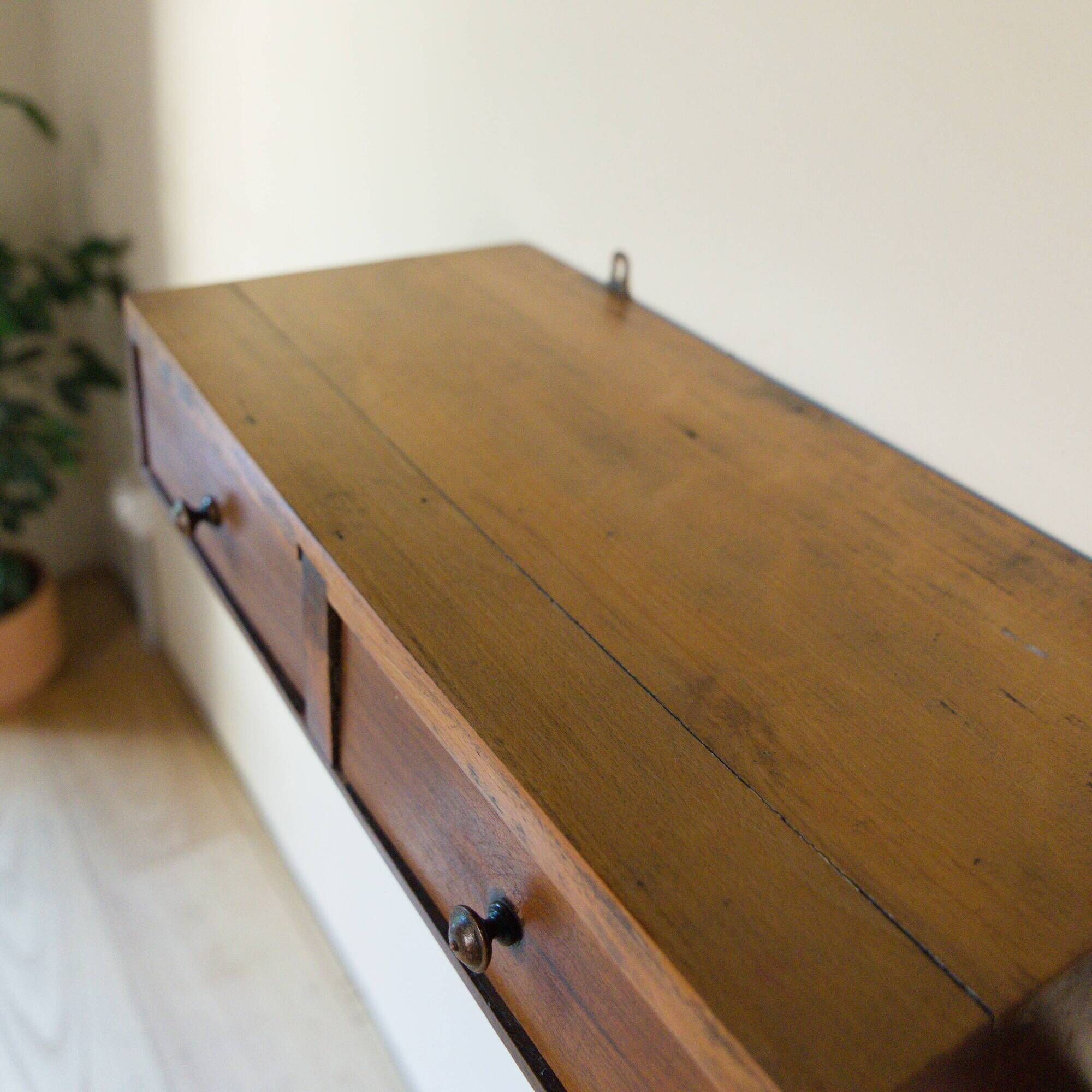 Small vintage wall console in patinated wood with two drawers.