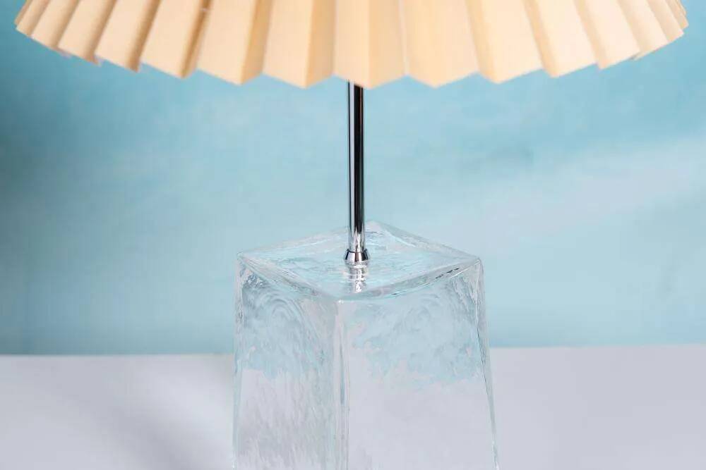 Minimalist glass table lamp from the 80s with a pleated shade.