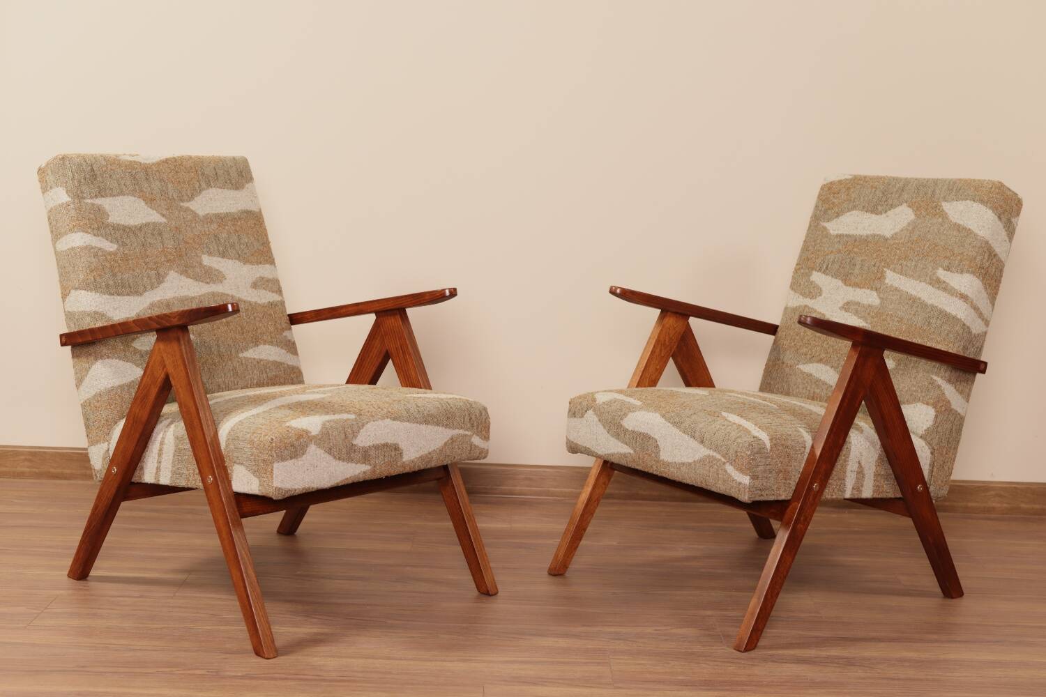 Pair of vintage lounge chairs in brown jacquard fabric and wood.