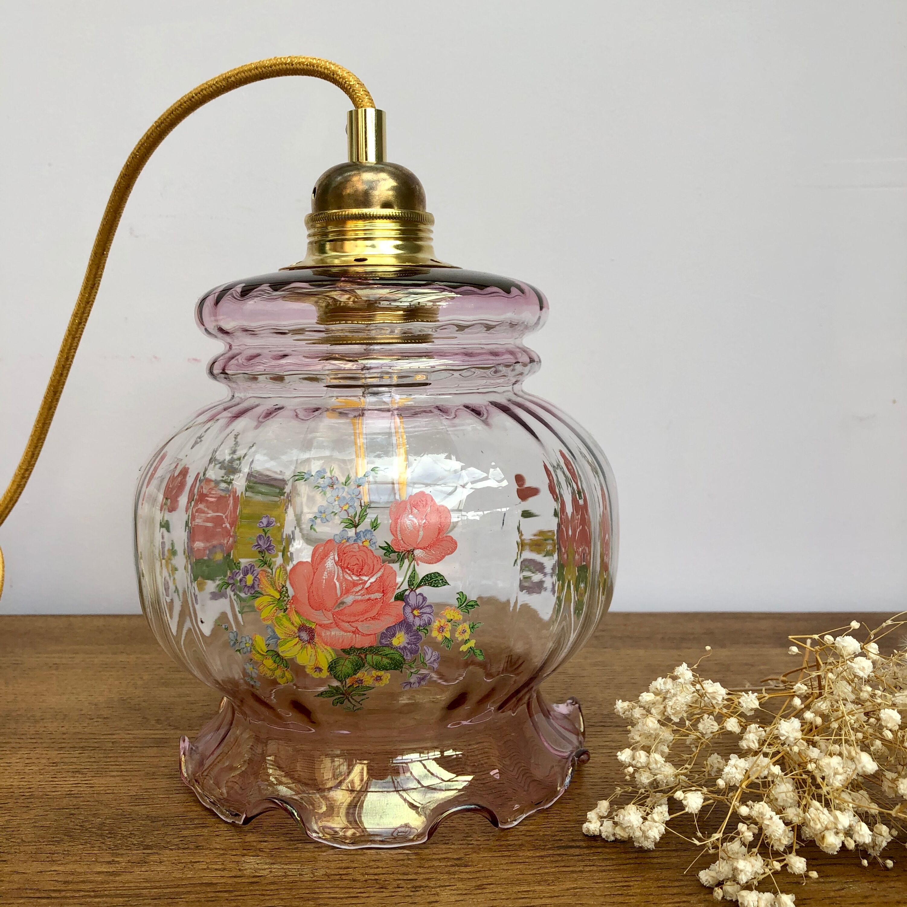 Vintage pink glass hand lamp with flower motifs