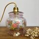 Vintage pink glass hand lamp with flower motifs