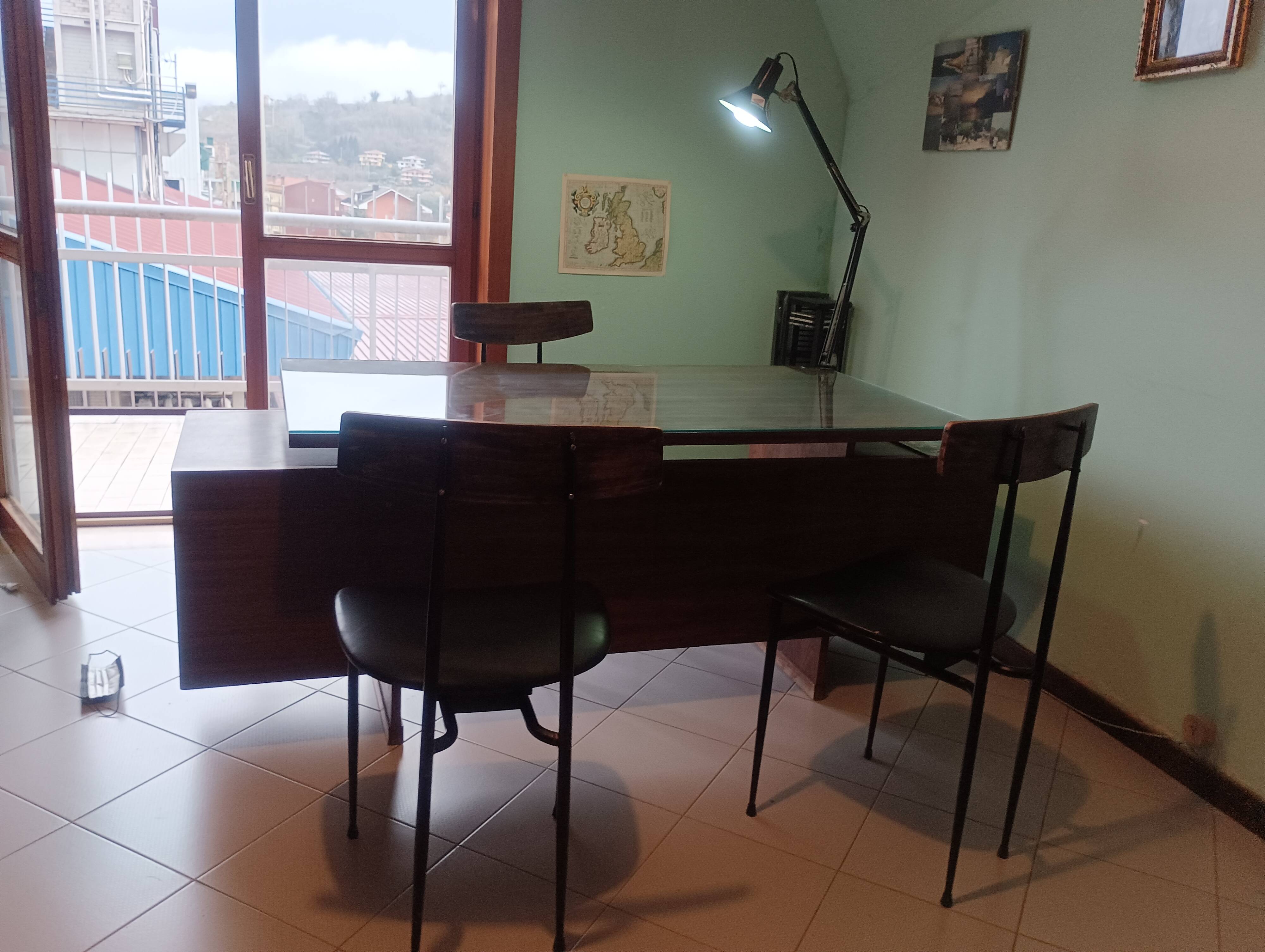Desk and 3 chairs in 1950s Italian modernist style in rosewood.