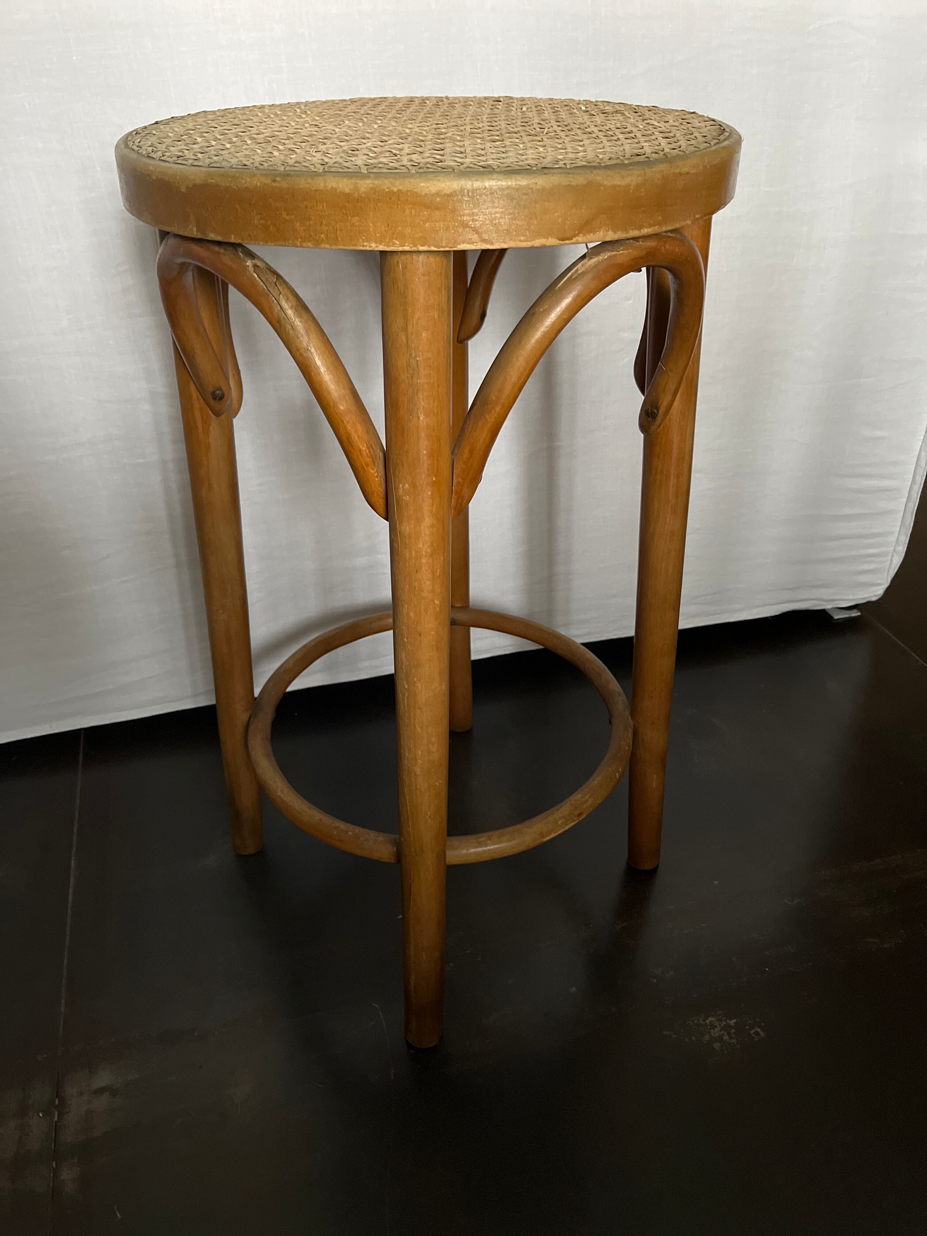 Curved wooden stool and cannage
