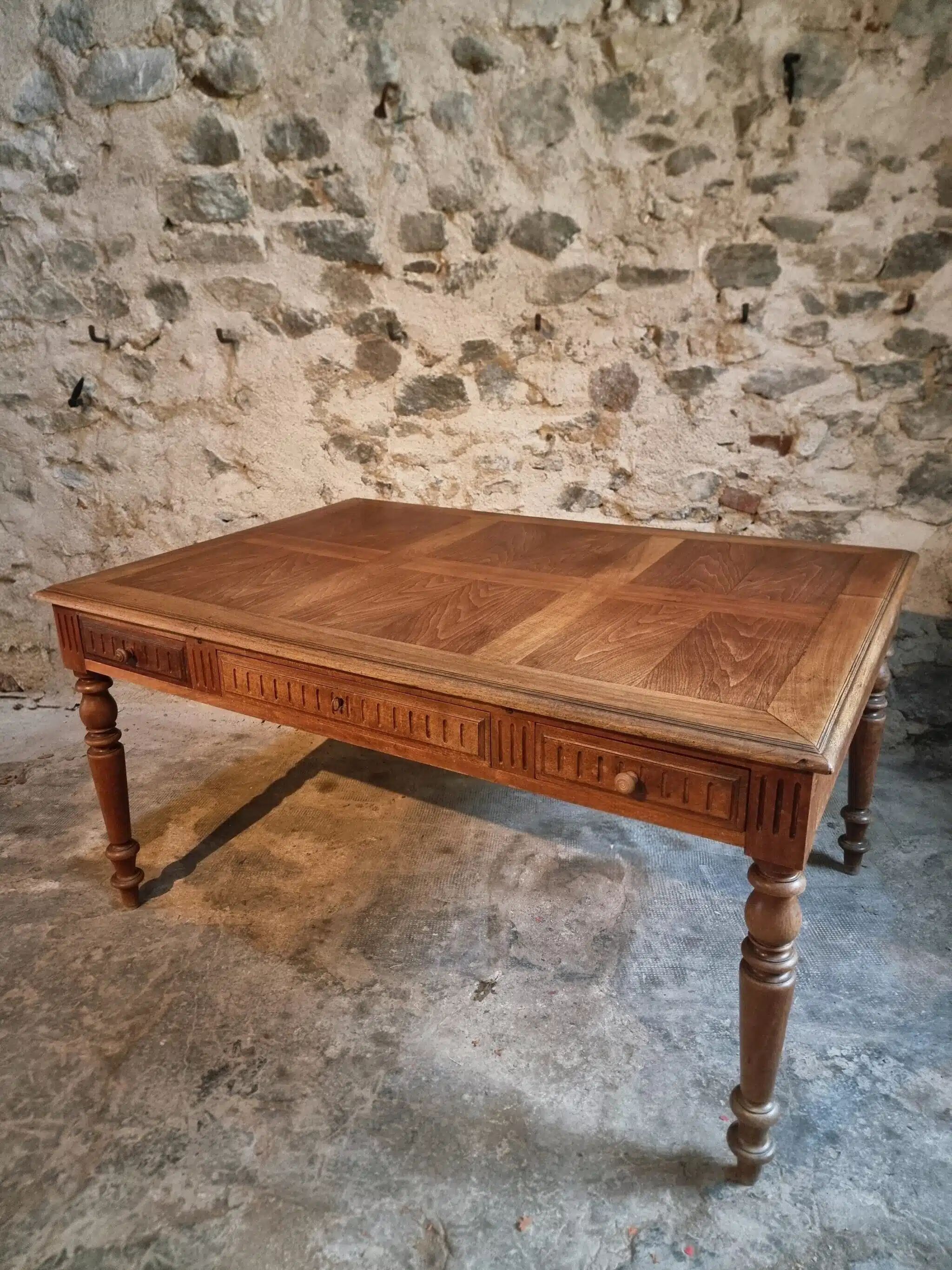 Antique French walnut table with six drawers, parquet top, early 20th century.