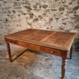 Antique French walnut table with six drawers, parquet top, early 20th century.