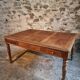 Antique French walnut table with six drawers, parquet top, early 20th century.