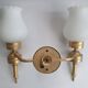 Three Empire style golden torch wall sconces