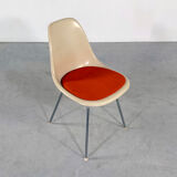 DSX chair with red cushion by Charles and Ray Eames edited by Herman Miller, 1960