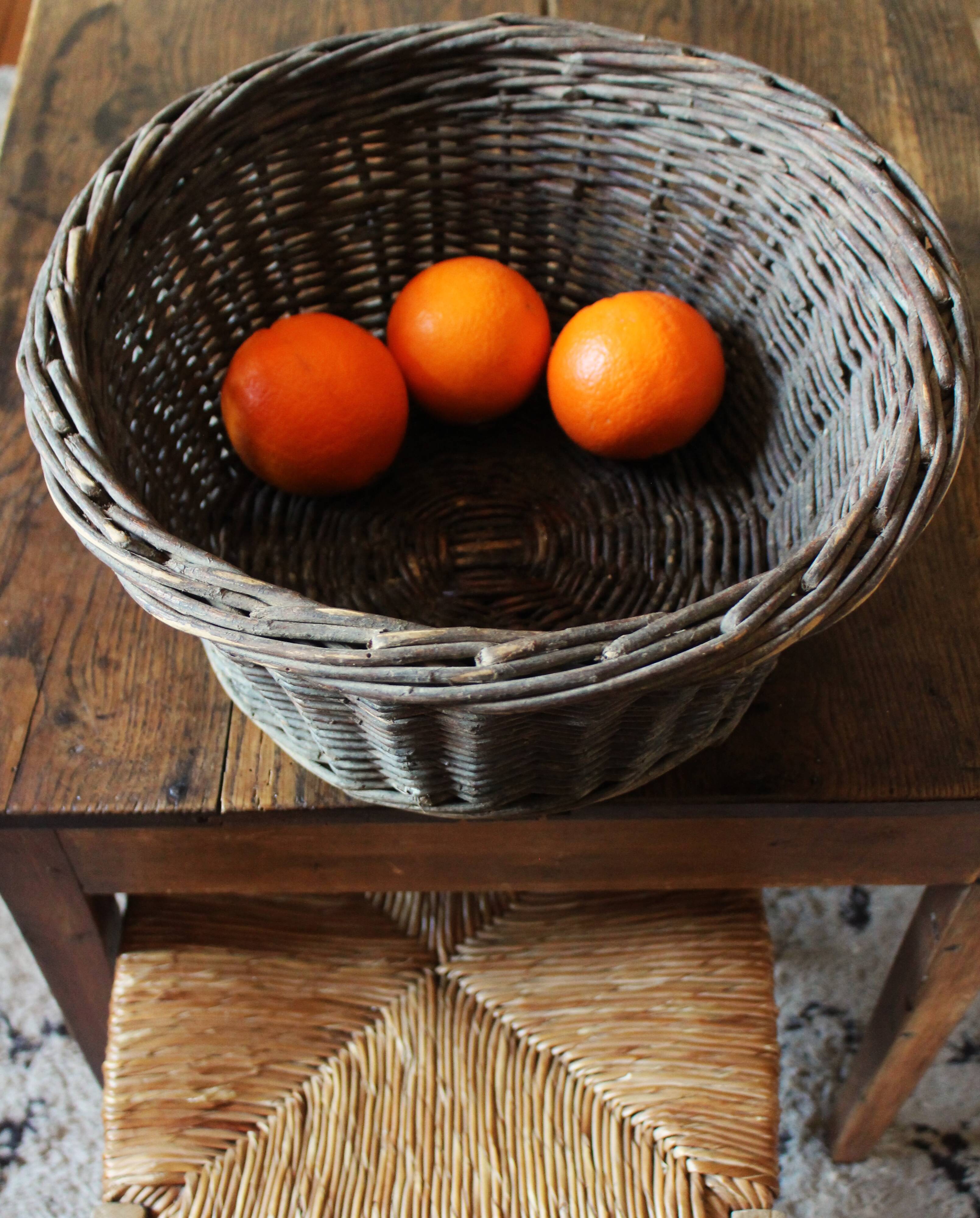Round wicker basket with a patina