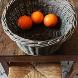 Round wicker basket with a patina