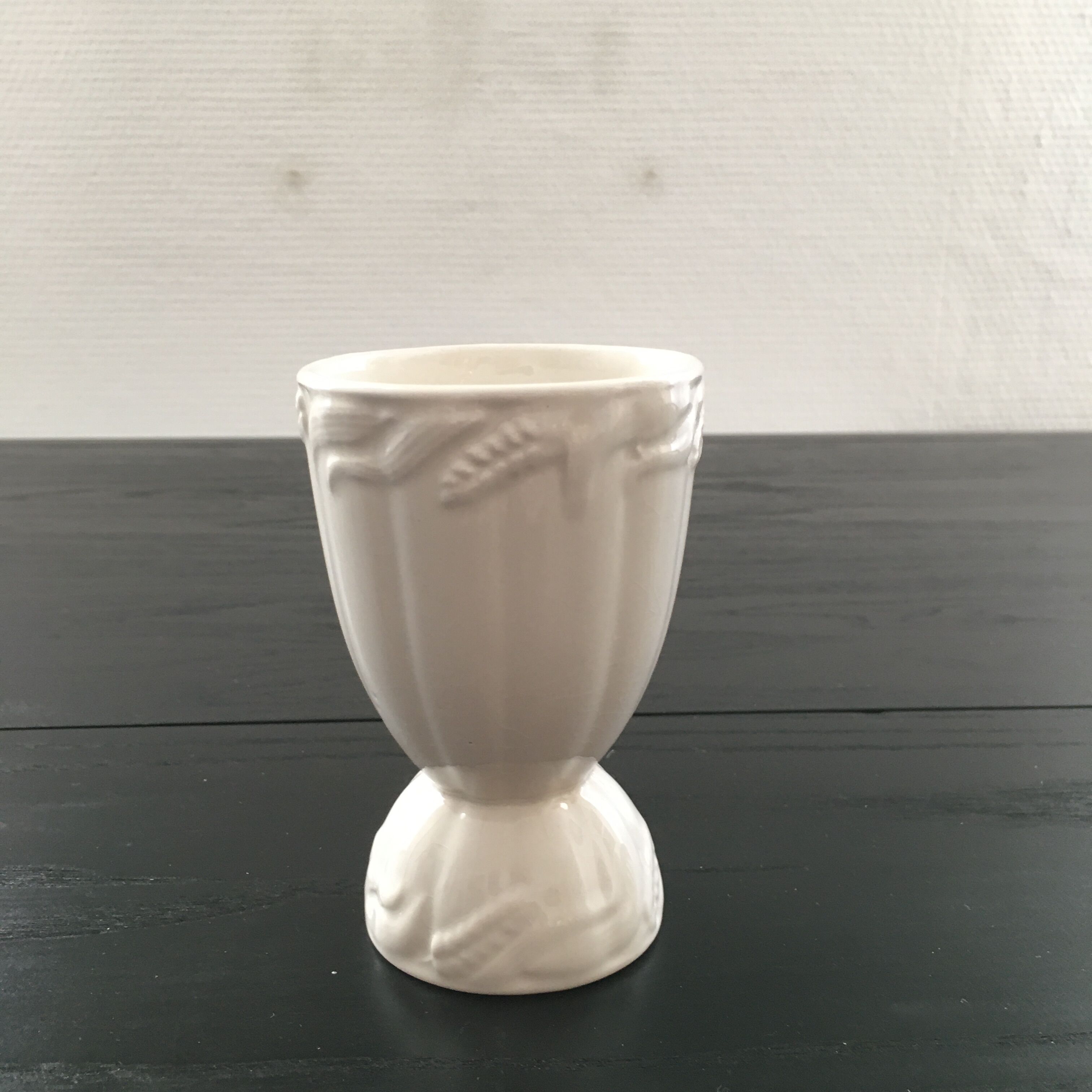 White vase with wheat decoration.