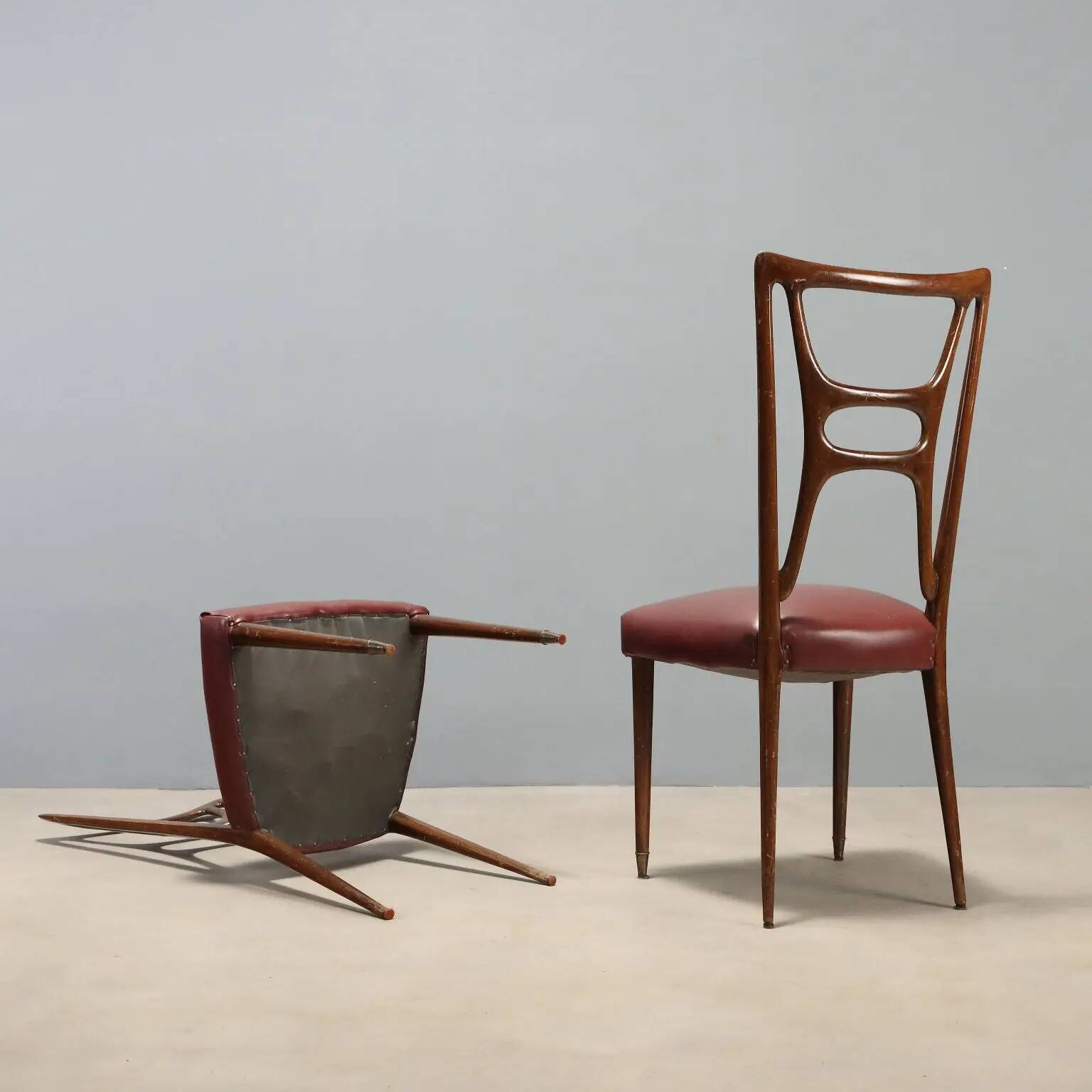 Set of six 1950s chairs with burgundy seats.
